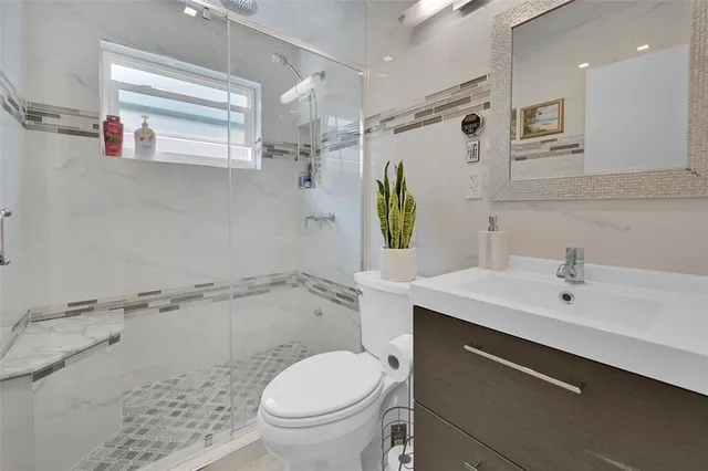 a bathroom with a sink toilet and shower
