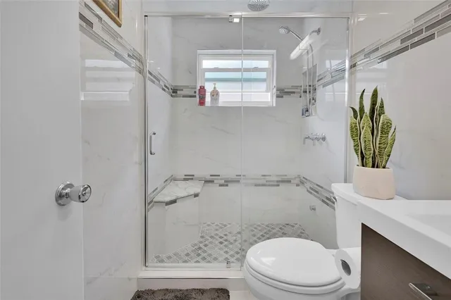 a white toilet sitting next to a bathroom sink