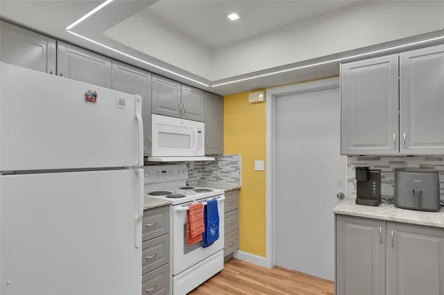 a white refrigerator freezer sitting inside of a kitchen