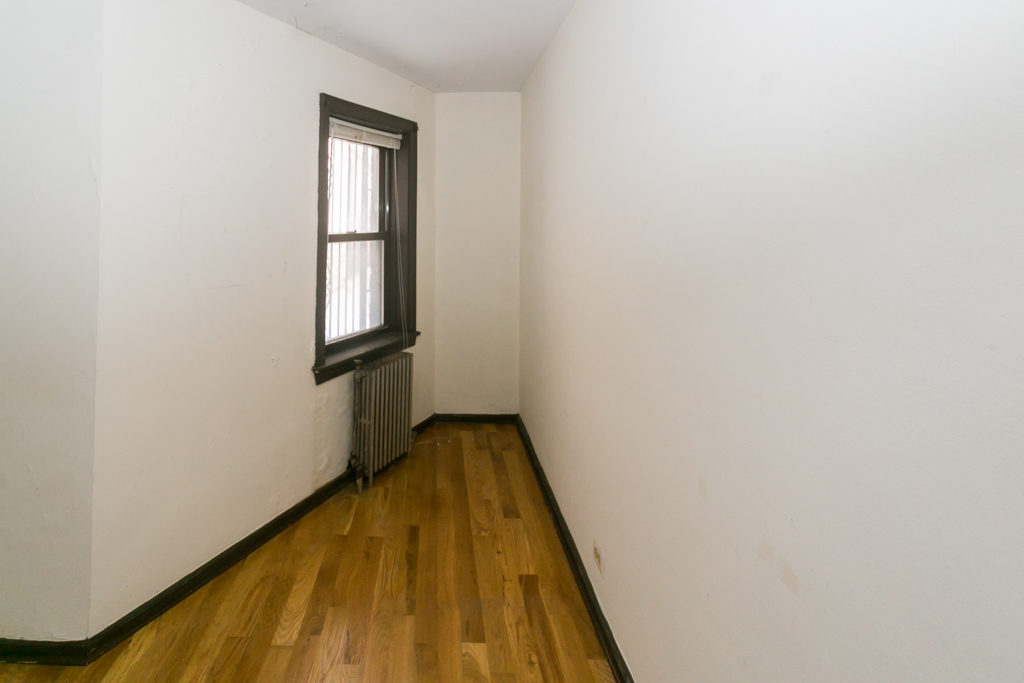 1211 West Elmdale Avenue, Unit 3 Chicago, IL 60660 - Photo 11 of 16 a view of a hallway with wooden floor and a window