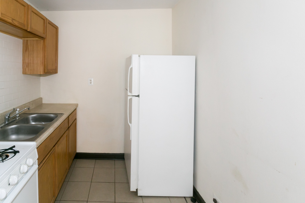 1211 West Elmdale Avenue, Unit 3 Chicago, IL 60660 - Photo 3 of 16 a kitchen with a sink and a refrigerator