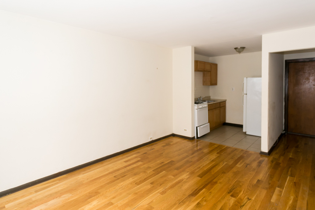 1211 West Elmdale Avenue, Unit 3 Chicago, IL 60660 - Photo 8 of 16 a view of a kitchen with wooden floor and electronic appliances