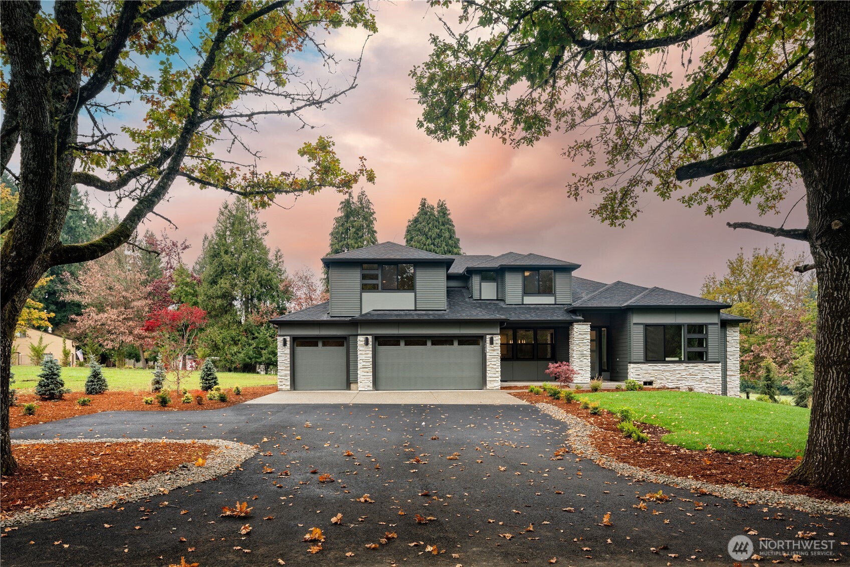 a front view of a house with a yard and garage