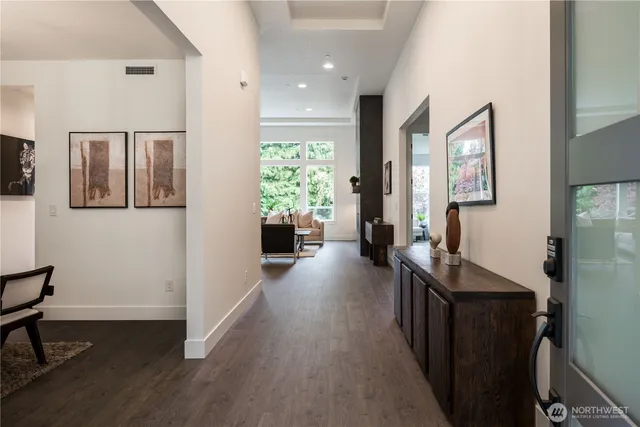 a living room with furniture a rug and a large window