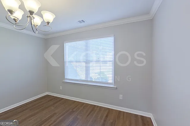 a view of a room with wooden floor and windows
