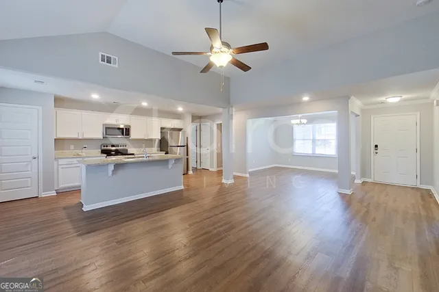 a view of kitchen with cabinets and wooden floor