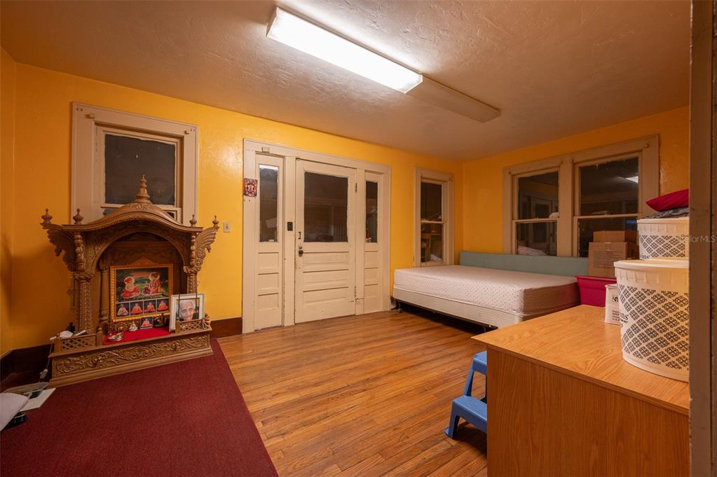4016 Northwest 6th Street Gainesville, FL 32609 - Photo 16 of 20 a bedroom with furniture and wooden floor