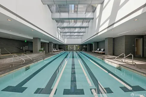 a view of swimming pool with a balcony furniture and a chandelier