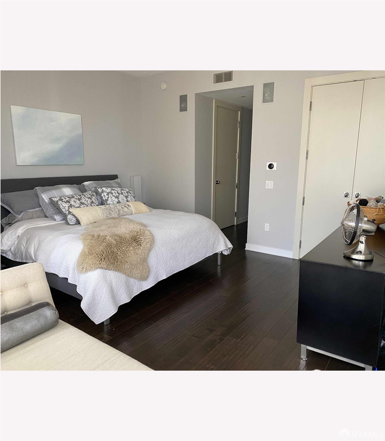 301 Mission Street, Unit 35C San Francisco, CA 94105 - Photo 9 of 28 a bedroom with a bed and wooden floor