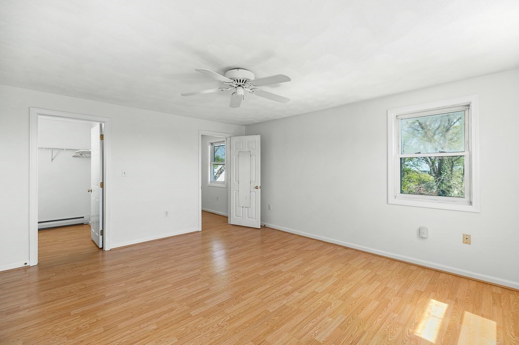 12 Crestview Terrace Gloucester, MA 01930 - Photo 18 of 27 a view of an empty room with a window and wooden floor
