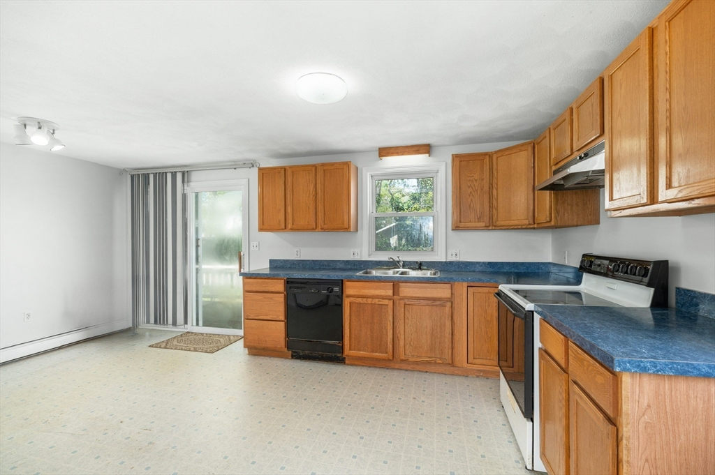 12 Crestview Terrace Gloucester, MA 01930 - Photo 9 of 27 a kitchen with stainless steel appliances granite countertop a sink stove and cabinets