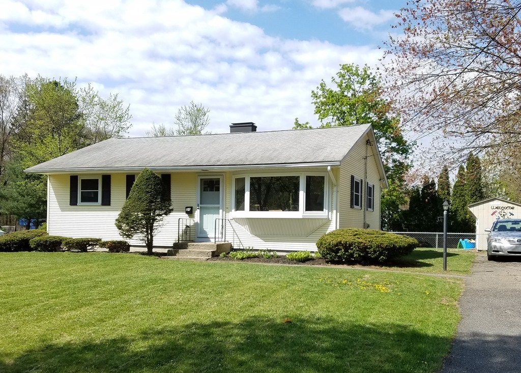 a front view of a house with a garden and porch