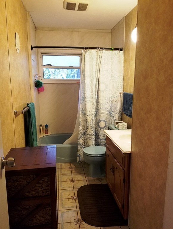 34 Higgins Street Springfield, MA 01108 - Photo 11 of 15 a bathroom with a sink a toilet and a mirror