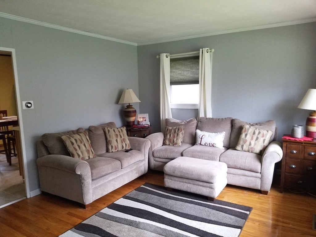 34 Higgins Street Springfield, MA 01108 - Photo 4 of 15 a living room with furniture and a lamp