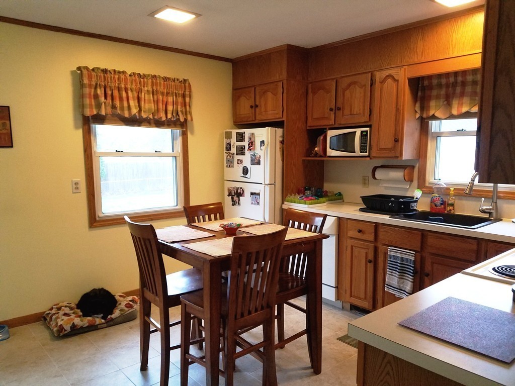 34 Higgins Street Springfield, MA 01108 - Photo 6 of 15 a kitchen with a table chairs a sink dishwasher window and cabinets