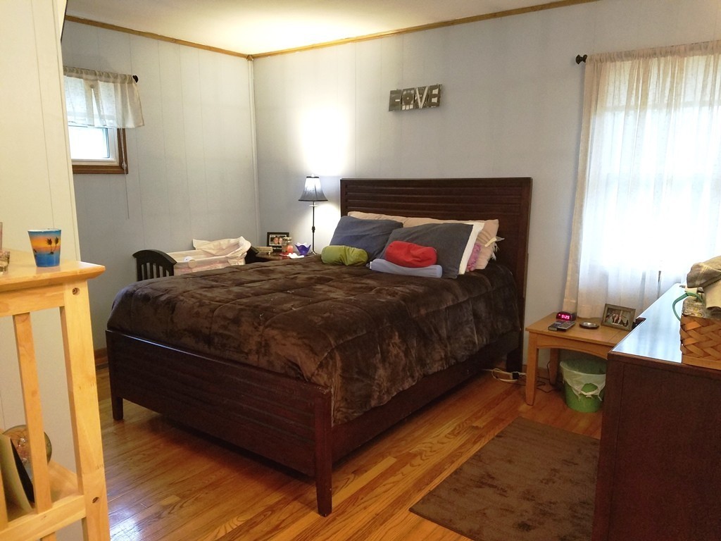 34 Higgins Street Springfield, MA 01108 - Photo 7 of 15 a bedroom with a bed and a potted plant on the dresser