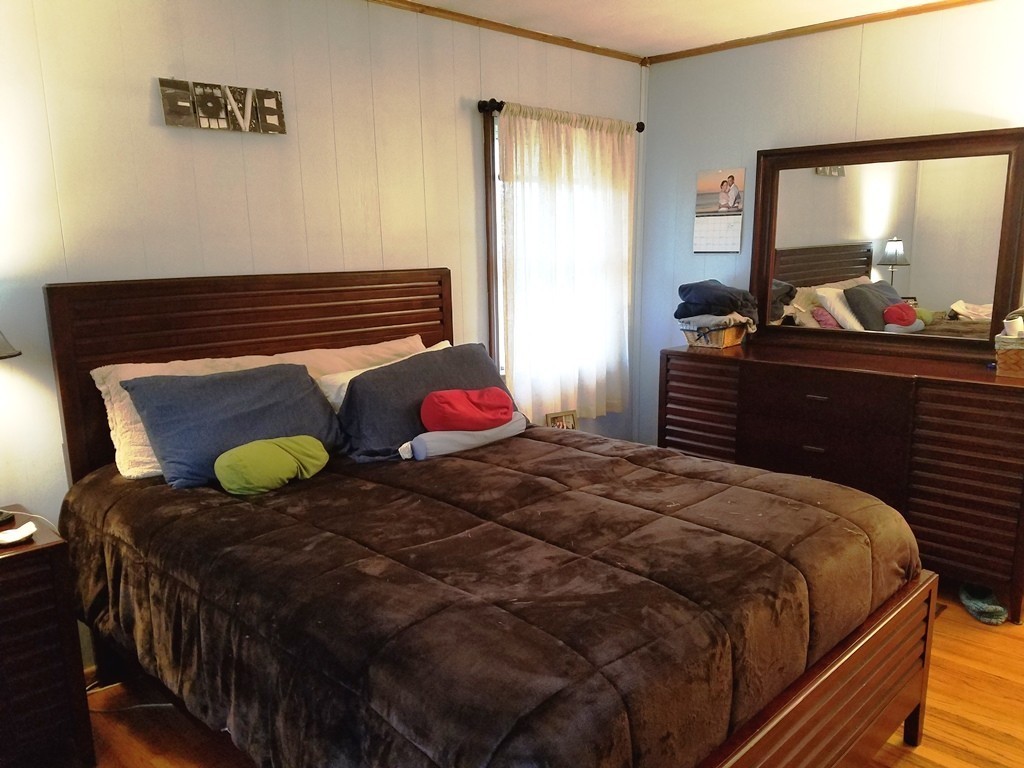 34 Higgins Street Springfield, MA 01108 - Photo 8 of 15 a bedroom with a bed and dresser