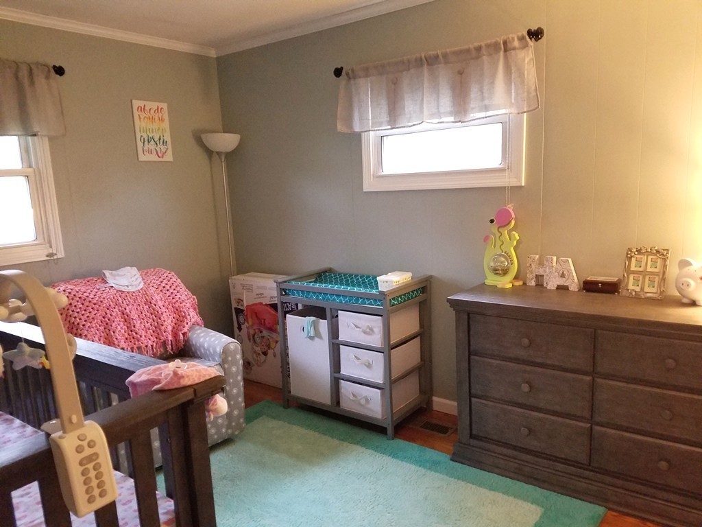 34 Higgins Street Springfield, MA 01108 - Photo 9 of 15 a bedroom with a bed and wooden floor