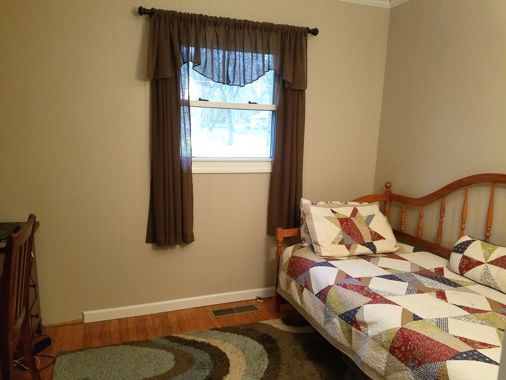 34 Higgins Street Springfield, MA 01108 - Photo 10 of 15 a bedroom with a bed and a window