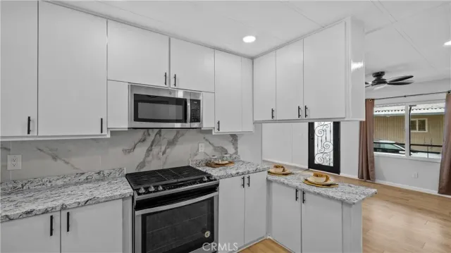 a kitchen with granite countertop a stove and a refrigerator