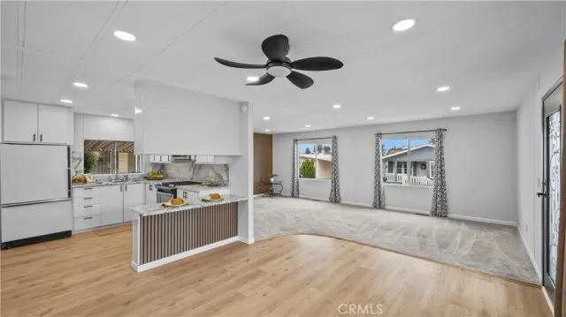 a living room with stainless steel appliances kitchen island granite countertop furniture and a kitchen view