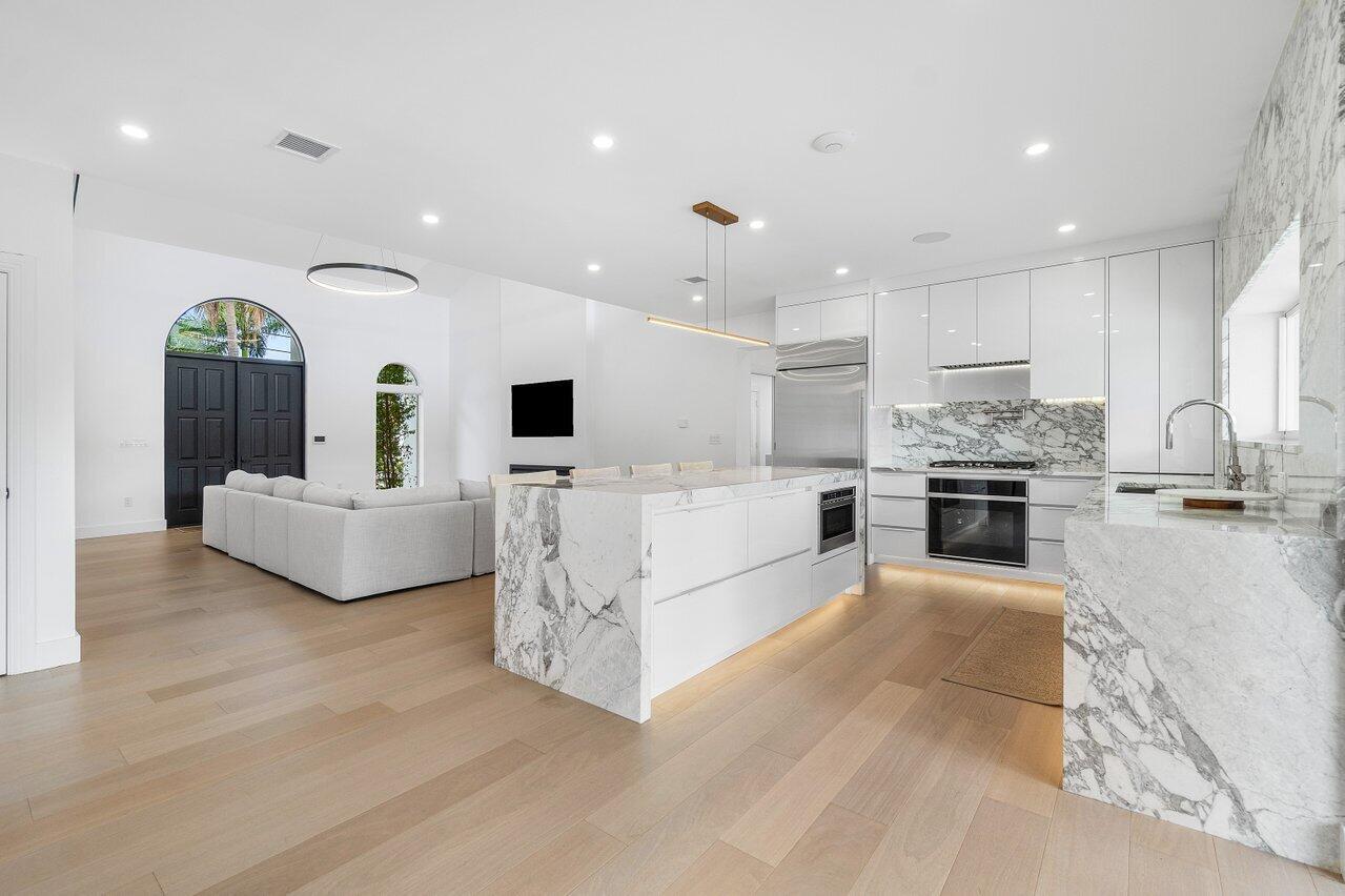 1366 Southwest 4th Court Boca Raton, FL 33432 - Photo 11 of 43 a large living room with stainless steel appliances kitchen island a large counter top stainless steel appliances and cabinets