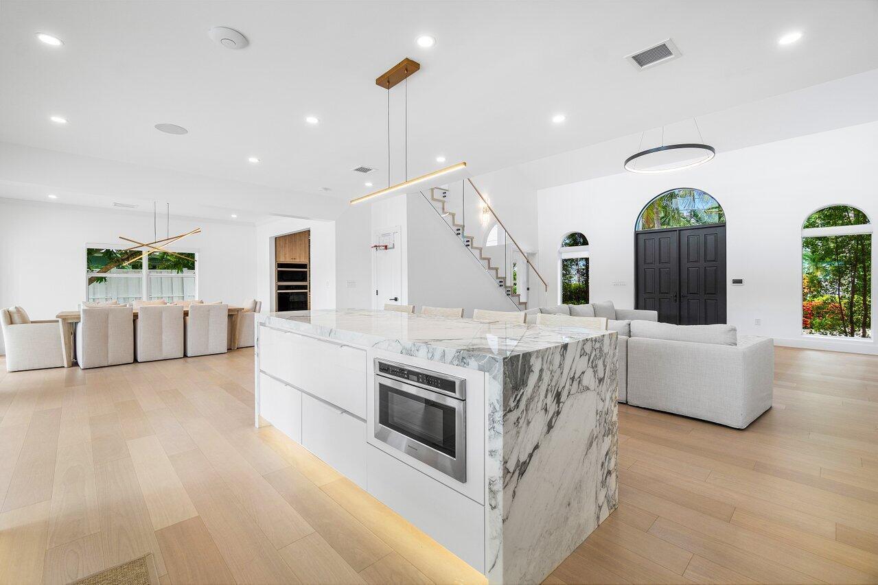 1366 Southwest 4th Court Boca Raton, FL 33432 - Photo 12 of 43 a kitchen with stainless steel appliances granite countertop a stove and a sink