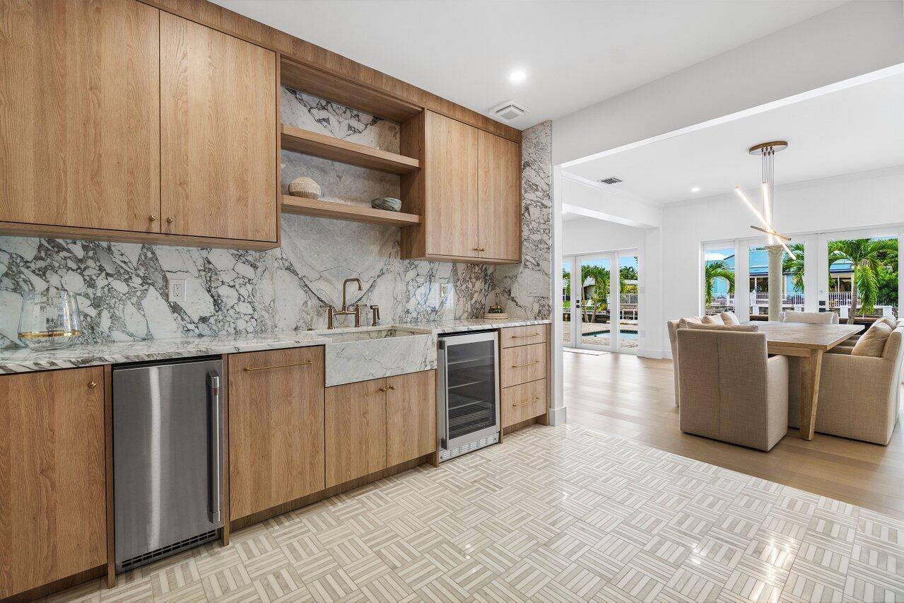 1366 Southwest 4th Court Boca Raton, FL 33432 - Photo 16 of 43 a kitchen with stainless steel appliances granite countertop a sink counter space cabinets and a large window