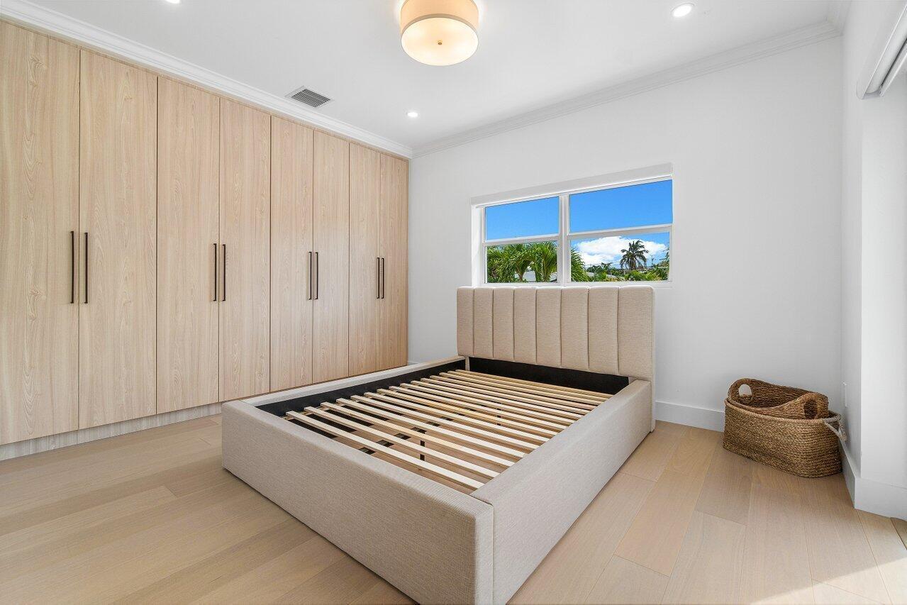 1366 Southwest 4th Court Boca Raton, FL 33432 - Photo 22 of 43 a bedroom with a bed and a window