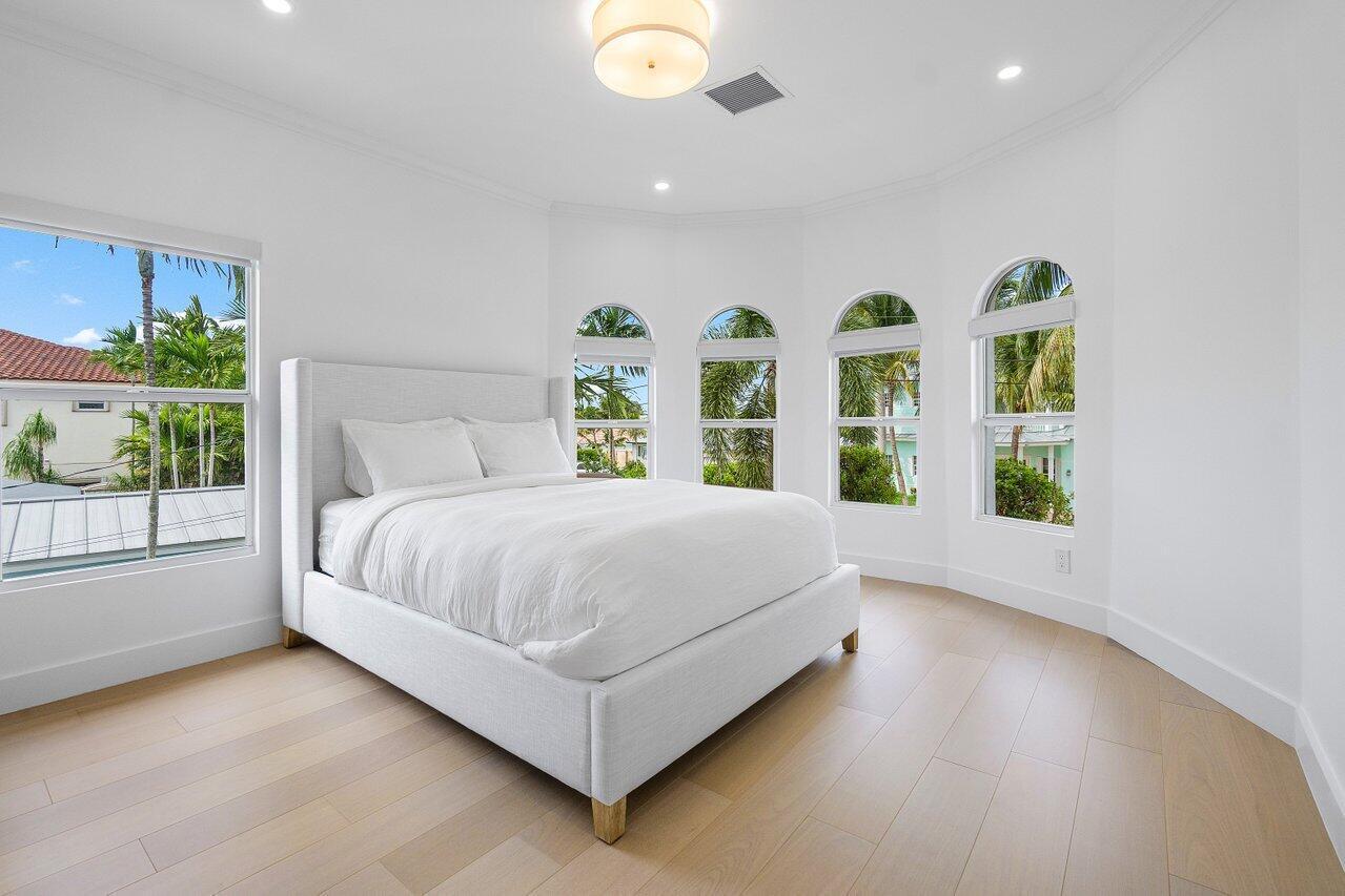 1366 Southwest 4th Court Boca Raton, FL 33432 - Photo 23 of 43 a bed sitting in a spacious bedroom next to a window