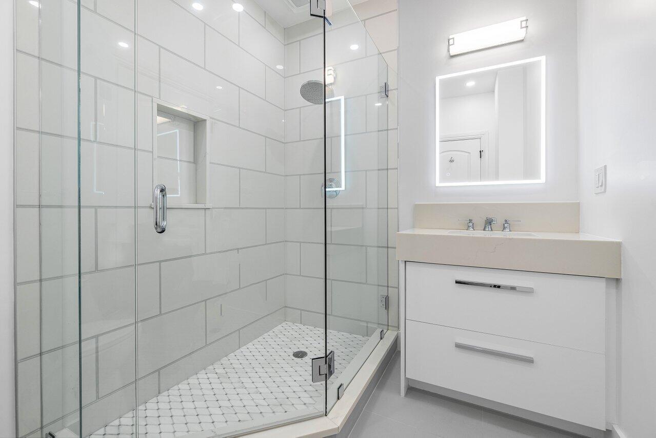 1366 Southwest 4th Court Boca Raton, FL 33432 - Photo 24 of 43 a bathroom with a sink a toilet and shower
