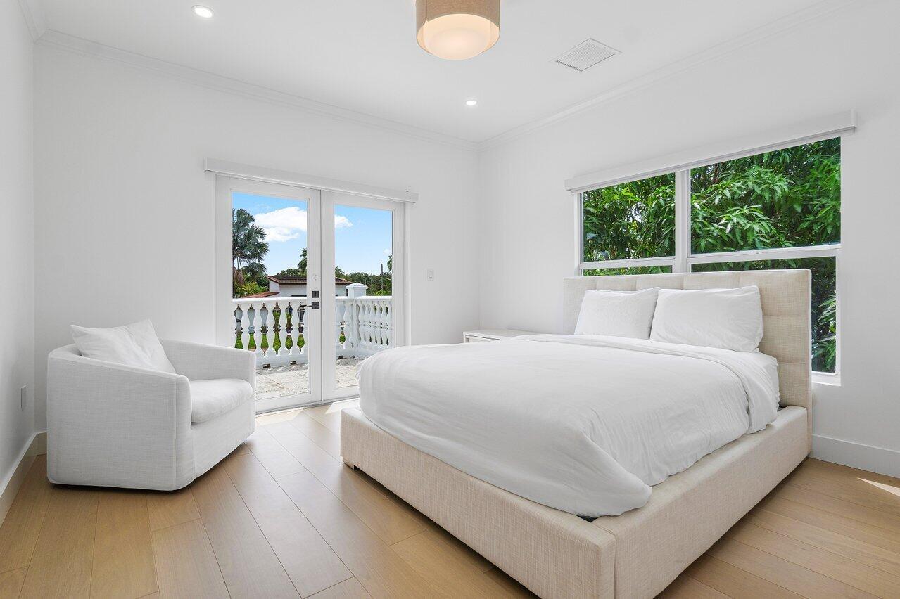 1366 Southwest 4th Court Boca Raton, FL 33432 - Photo 25 of 43 a bedroom with a bed and a table