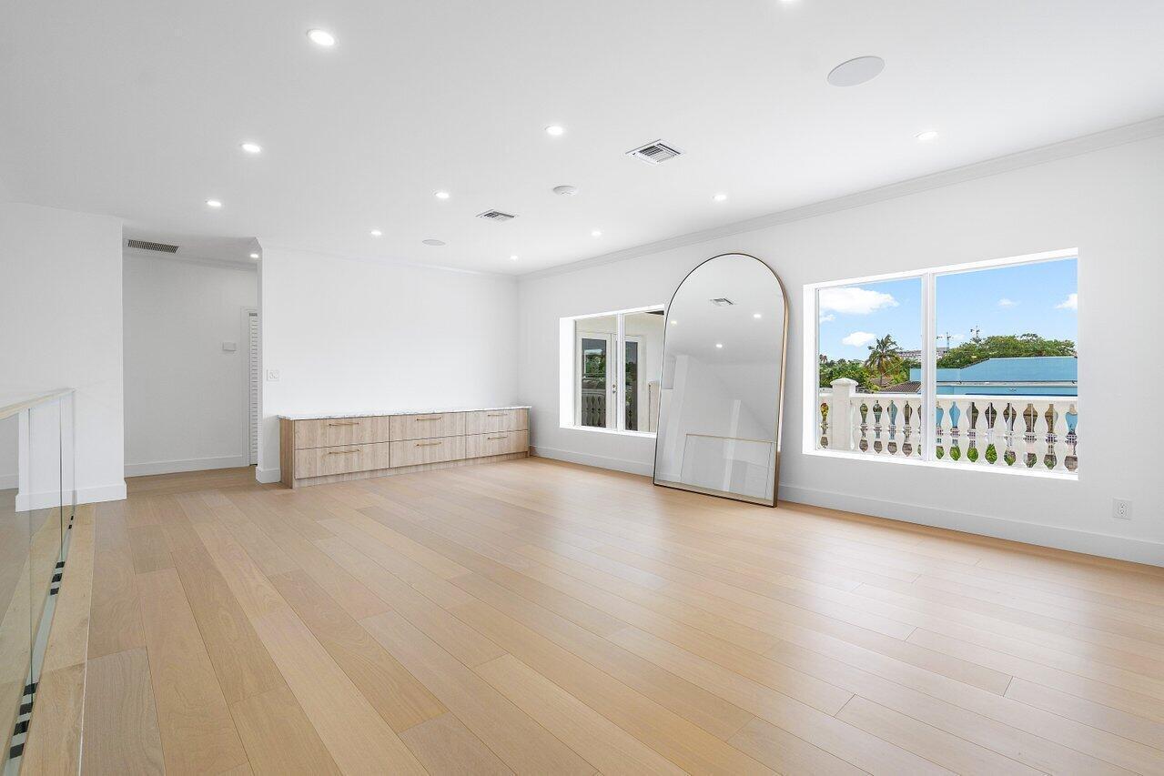 1366 Southwest 4th Court Boca Raton, FL 33432 - Photo 26 of 43 an empty room with wooden floor and windows