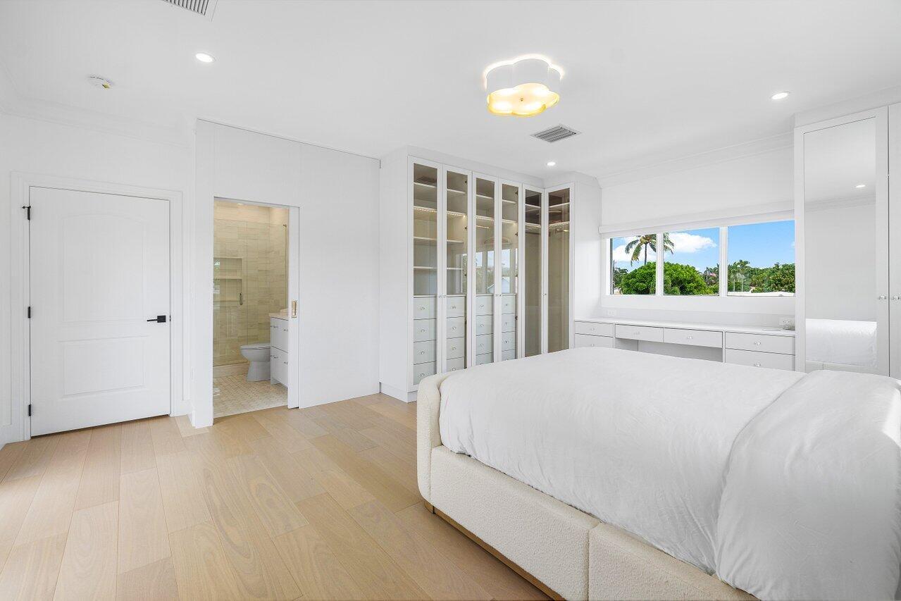 1366 Southwest 4th Court Boca Raton, FL 33432 - Photo 29 of 43 a bedroom with a bed and a large window