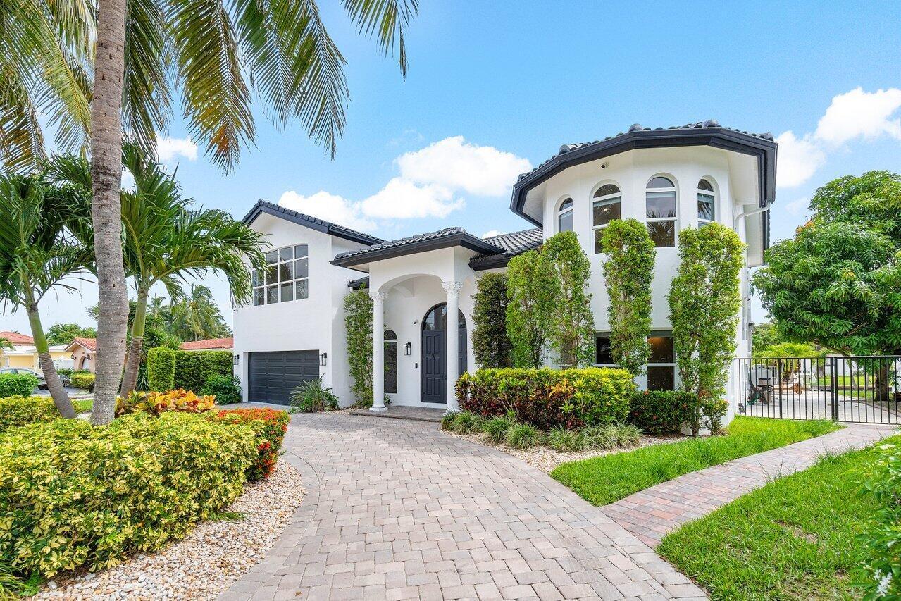 1366 Southwest 4th Court Boca Raton, FL 33432 - Photo 3 of 43 a front view of a house with a yard