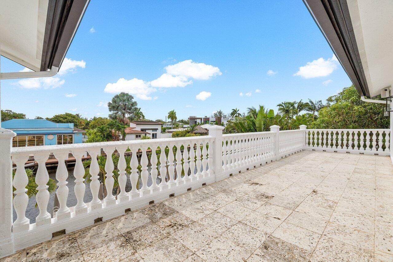 1366 Southwest 4th Court Boca Raton, FL 33432 - Photo 31 of 43 a view of a balcony with wooden fence