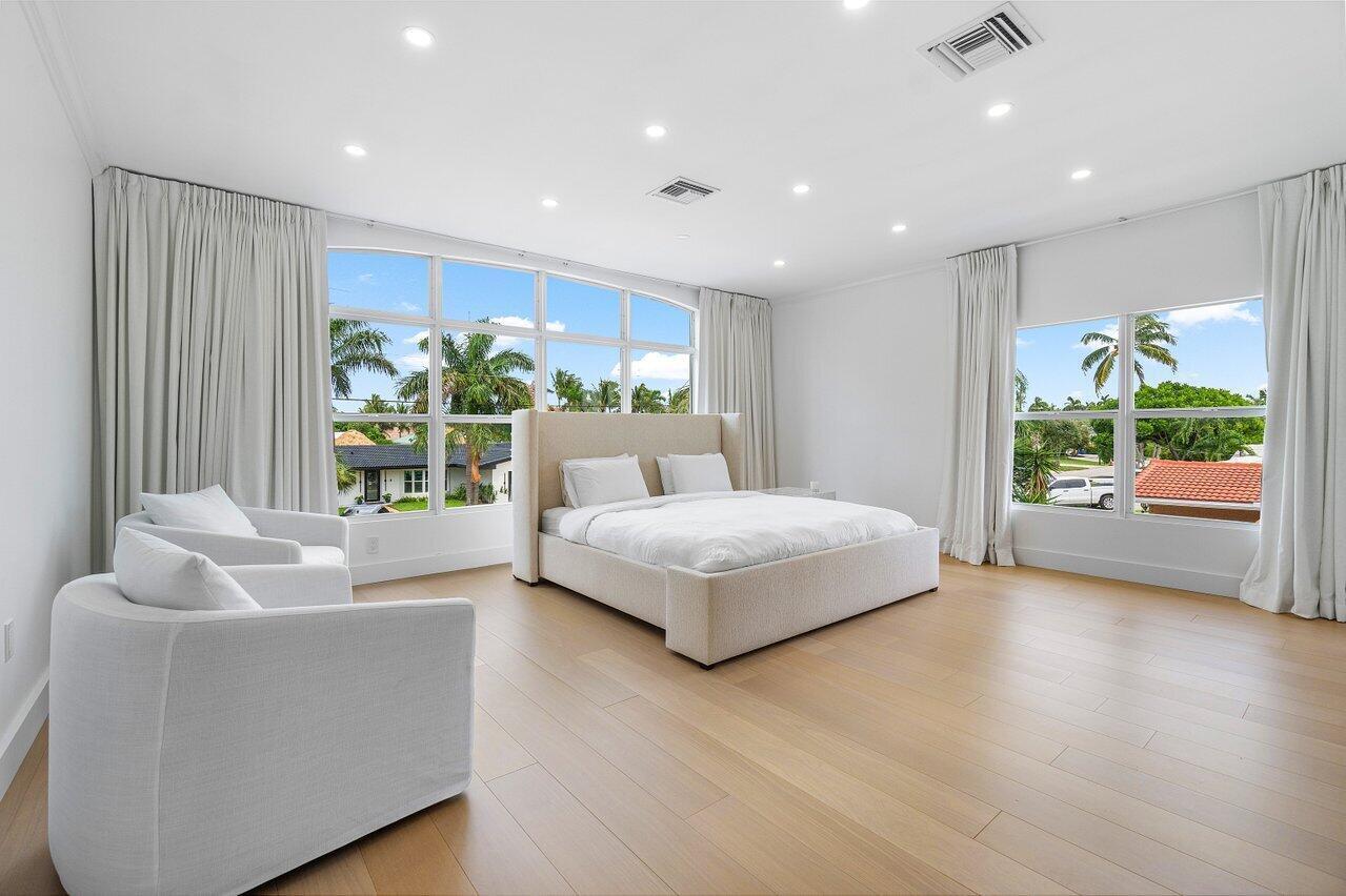 1366 Southwest 4th Court Boca Raton, FL 33432 - Photo 32 of 43 a spacious bedroom with a large bed and a couch