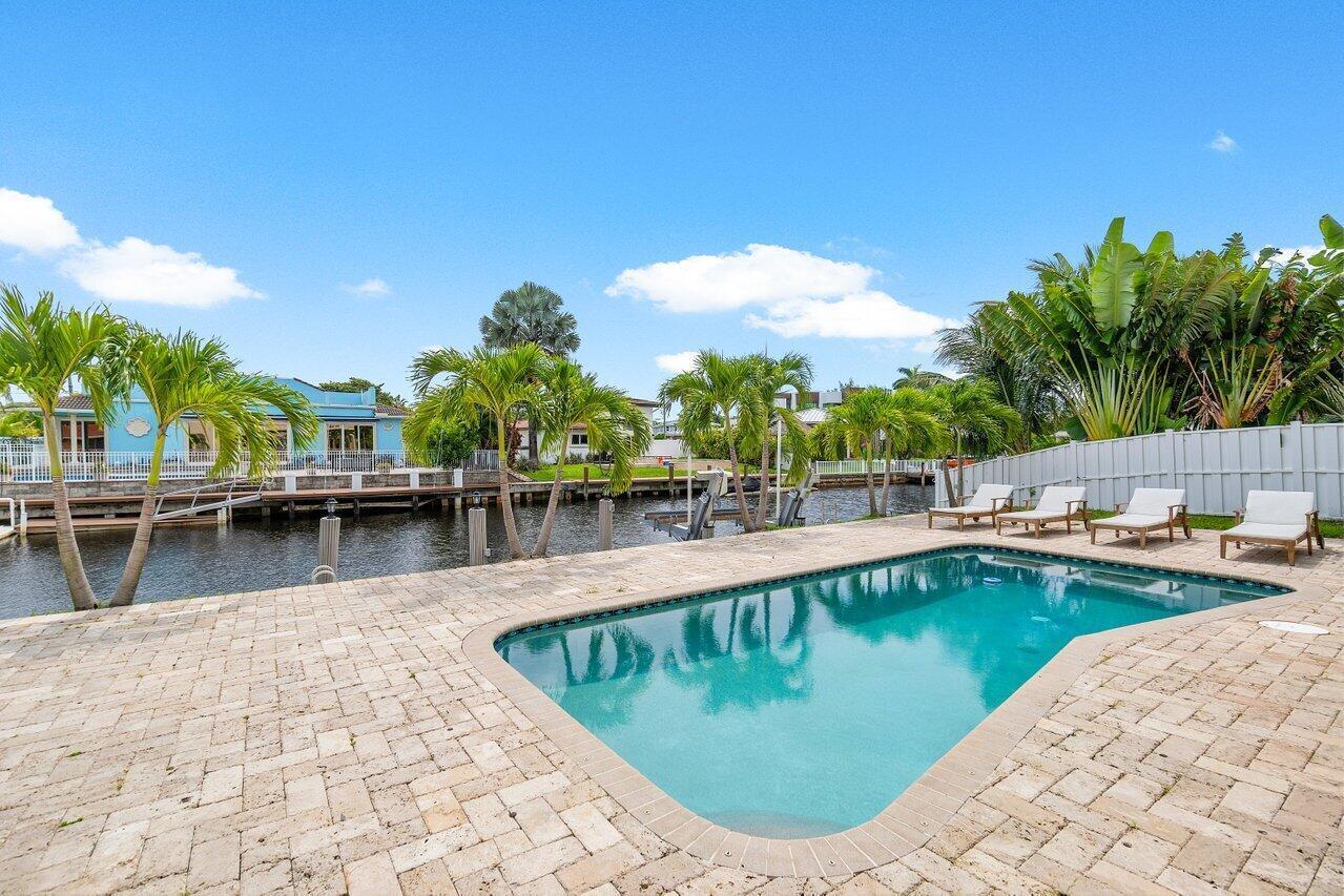 1366 Southwest 4th Court Boca Raton, FL 33432 - Photo 38 of 43 a view of a swimming pool with a lounge chair