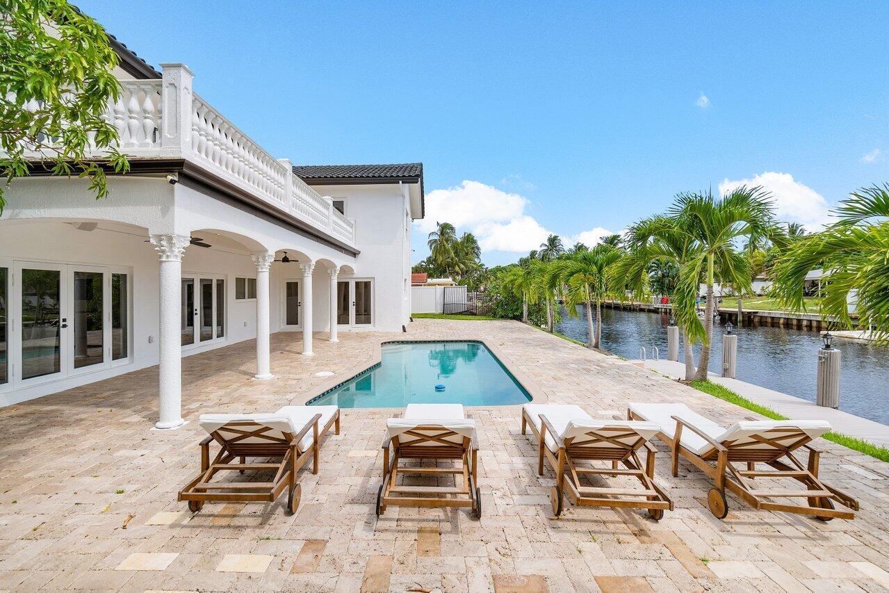 1366 Southwest 4th Court Boca Raton, FL 33432 - Photo 40 of 43 a view of backyard with swimming pool table and chairs