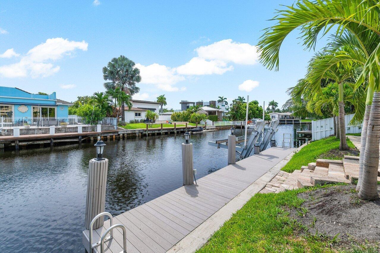 1366 Southwest 4th Court Boca Raton, FL 33432 - Photo 42 of 43 a view of a lake with a yard and a large window