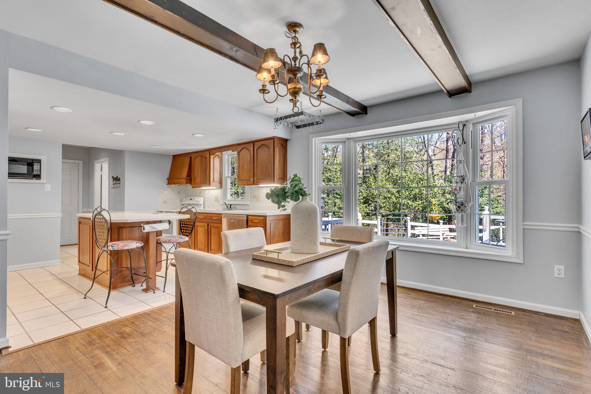 10231 3 Doctors Road Dunkirk, MD 20754 - Photo 15 of 63 a view of a dining room with furniture a chandelier and wooden floor