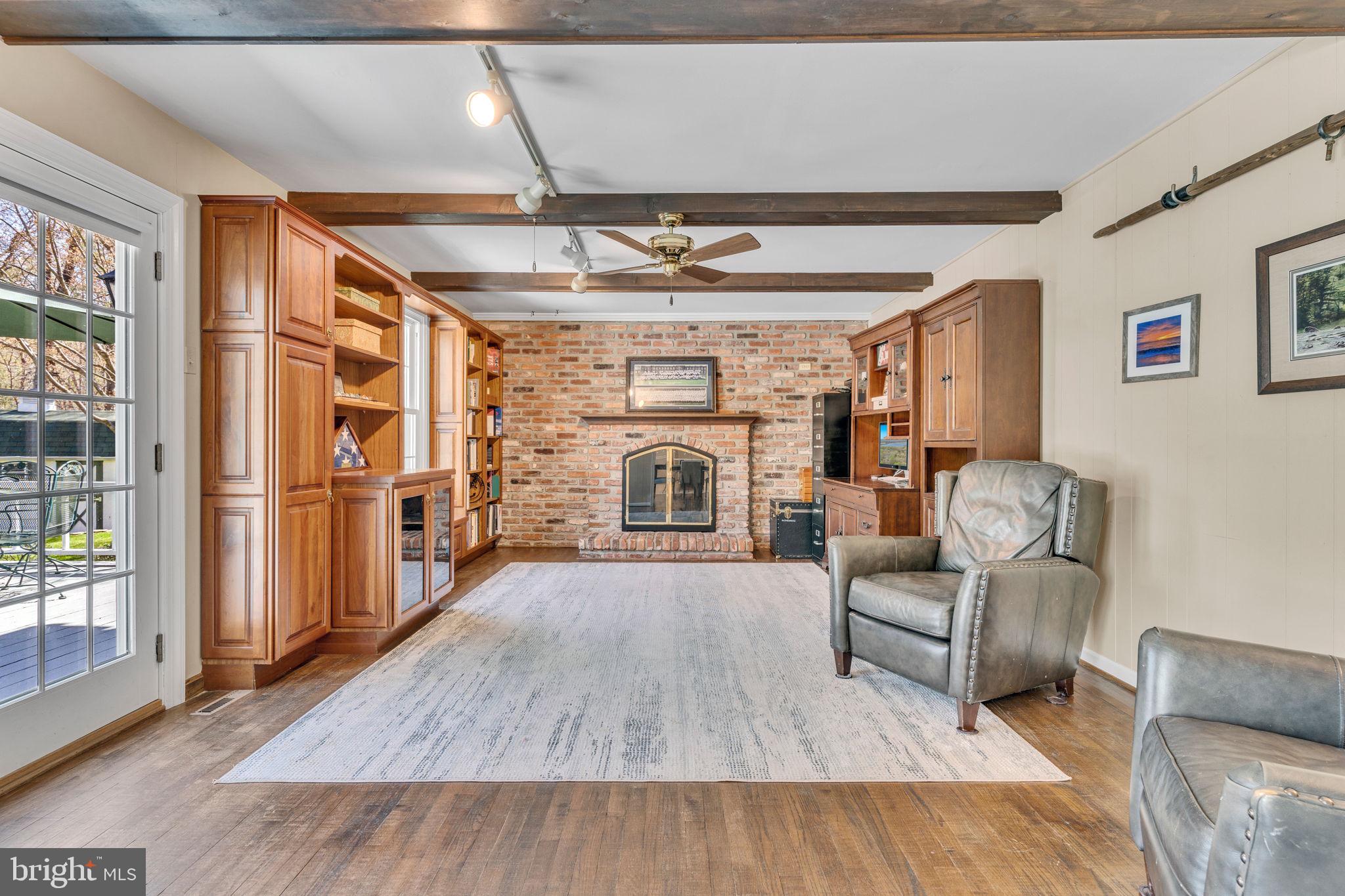 10231 3 Doctors Road Dunkirk, MD 20754 - Photo 18 of 63 a living room with furniture fireplace and wooden floor