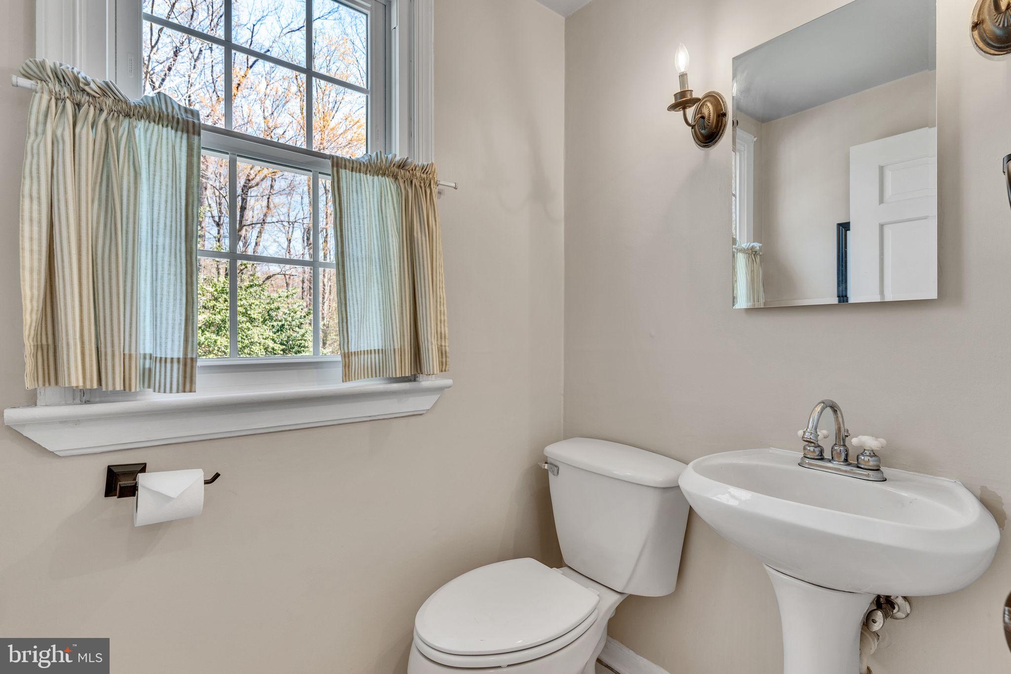 10231 3 Doctors Road Dunkirk, MD 20754 - Photo 20 of 63 a bathroom with a sink a mirror and a toilet