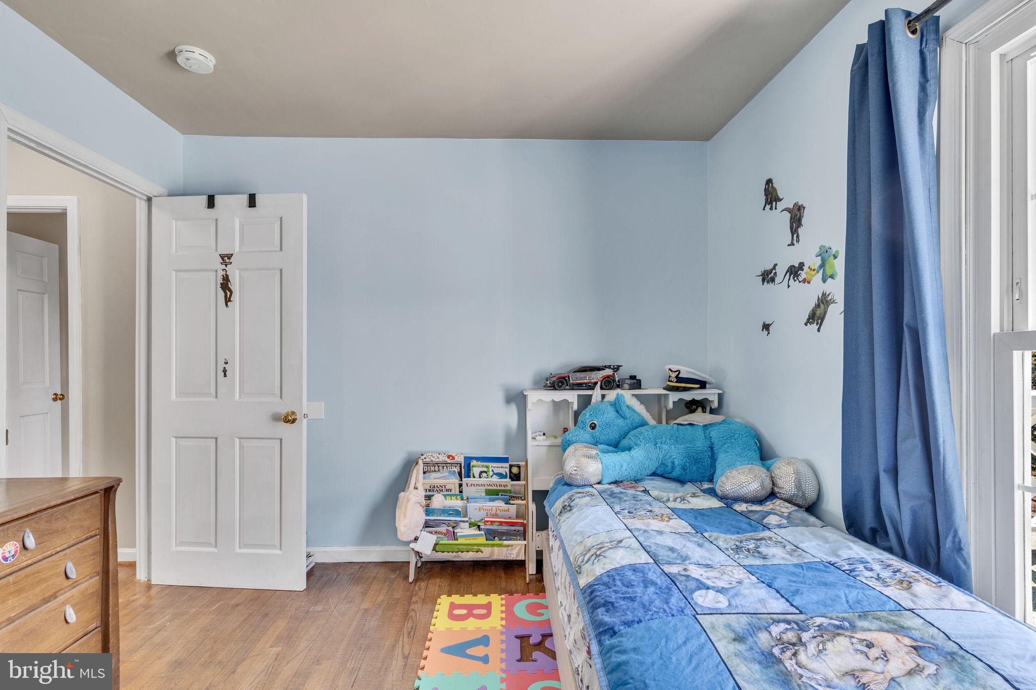10231 3 Doctors Road Dunkirk, MD 20754 - Photo 34 of 63 a bedroom with a bed and wooden floor