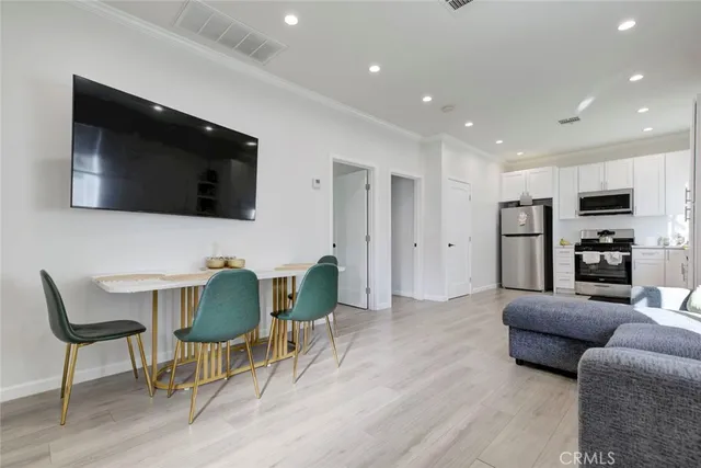 a living room with furniture and a open kitchen view