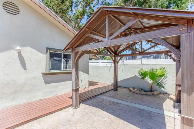 a roof deck with table and chairs