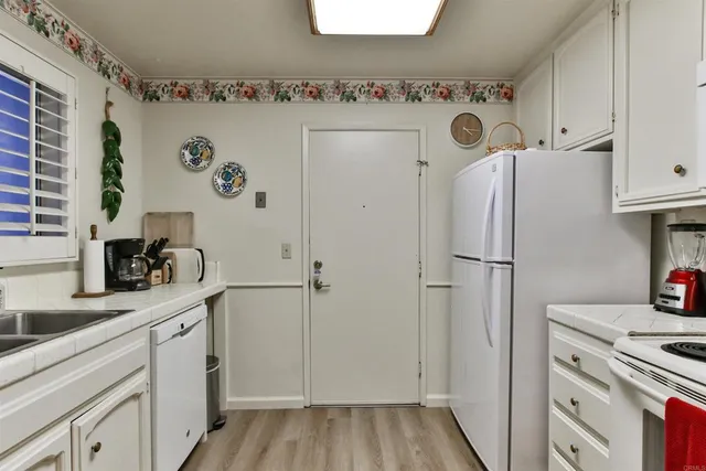 a kitchen with cabinets appliances and a counter space