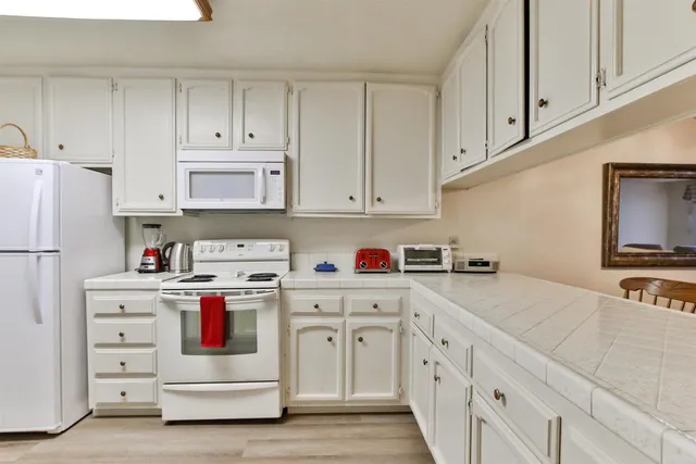 a kitchen with a refrigerator and a stove