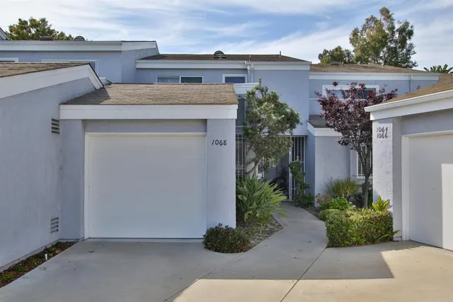 a view of a house with potted plants