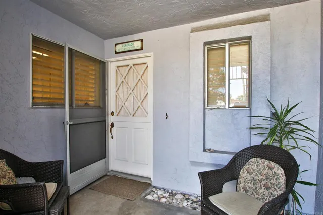 a potted plant sitting in front of a house with a glass door